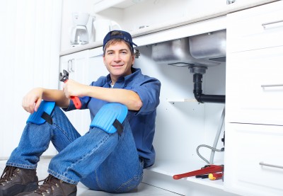 Jack, one of our plumbers in Bethesda, MD is posing near the kitchen sink