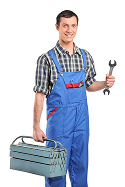 John holding a wrench in one hand and in the other his plumbing tool box