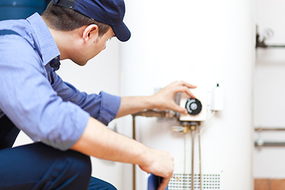 one of our plumbers in Bethesda, MD is repairing a water heater